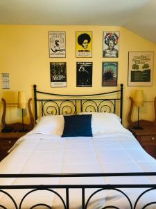 a bedroom with a bed with posters on the wall at Auberge De Mon Petit Chum B&B in Wakefield