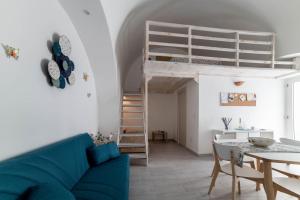 a living room and dining room with a loft bed at La Nghioscia in Grottaglie