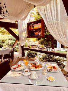 a table with plates of food on top of it at Hotel Boavista in Timişoara