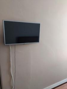 a flat screen tv hanging on a wall at Areia Da Foz in Figueira da Foz +53 photos