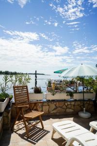 eine Terrasse mit einem Tisch, Stühlen und einem Sonnenschirm in der Unterkunft Sea view apartment Umag 1 in Umag