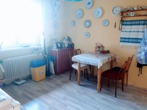 a kitchen with a table and chairs and plates on the wall at Ubytovanie u Marty in Veľký Meder