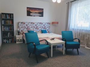 a bedroom with a bed and a table and chairs at Ubytovanie u Marty in Veľký Meder