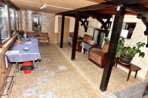 a living room with a table and chairs and a room with at CASA TUDOR in Buşteni