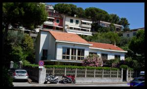 a house with two motorcycles parked in front of a fence at Villa Elena in Portovenere