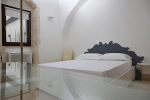 Postel nebo postele na pokoji v ubytování Antico Convento Dei Cappuccini