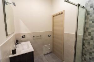 a bathroom with a sink and a shower at La Casetta sul Mare in Isola delle Femmine