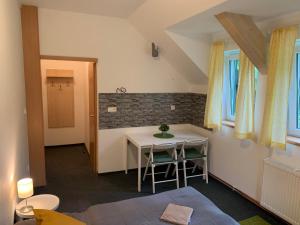 a small room with a table and a table and chairs at Penzion Zelené Údolí in Janske Lazne