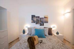 a bedroom with a large bed with blue pillows at Amalfi Casamia B&B in Amalfi
