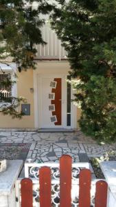 a front door of a house with a red door at 2BR Apartment Hedvig in Jadranovo