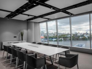 a conference room with a white table and chairs at Hotel Residence in Yekaterinburg