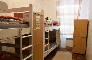 a bedroom with two bunk beds and a window at Hedonist Hostel in Belgrade