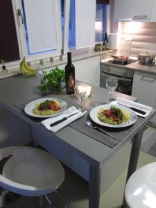 two plates of food on a table in a kitchen at Apartments Klementina in Postira