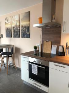 a kitchen with a stove top oven next to a table at Guetsel-Lodge - Δ in Gütersloh