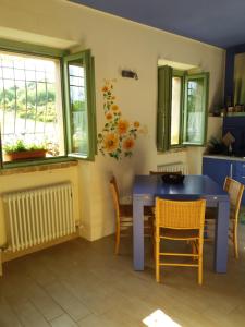 a dining room with a blue table and chairs at Agriturismo Vellaneta in Cagli +22 photos