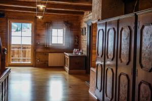 a room with wooden walls and a large wooden door at Angererhof in Jochberg