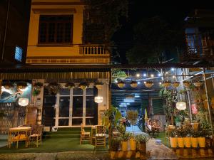 a building with a patio with tables and chairs at night at Cao Bang Eco Homestay in Cao Bằng