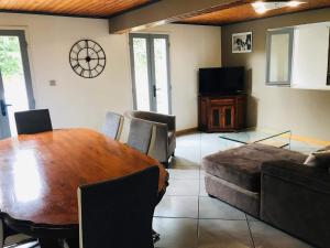 a living room with a wooden table and a couch at La Madeleine in Cilaos