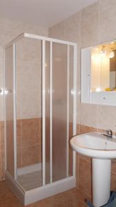 a bathroom with a shower and a sink at Duplex Oceanos in Ponta Delgada