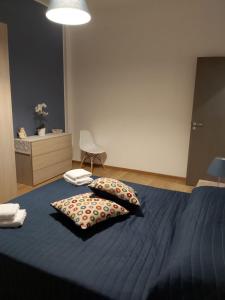 a bedroom with a blue bed with two pillows on it at Casa Giulia Vacanze in Baronissi