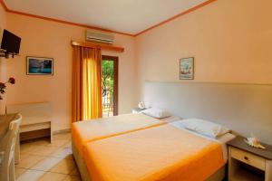 a bedroom with a bed and a window at Elpidas house in Parga