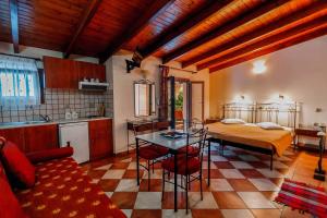 a kitchen and a living room with a bed and a table at Elpidas house in Parga