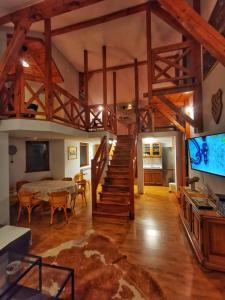 a large living room with a staircase and a dining room at Greencajt in Jakopovec