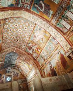 a ceiling with paintings on it in a building at Sognando Bominaco - Dimora il Milord in Bominaco