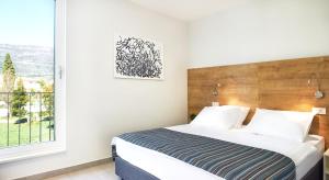 Posteľ alebo postele v izbe v ubytovaní Hotel Štacija