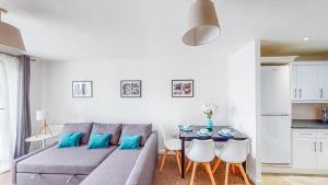 a living room with a couch and a table with chairs at Tamblin Lodge in Hatfield