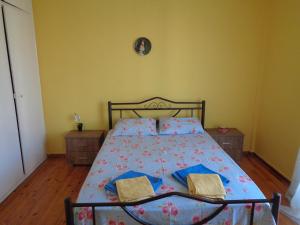 a bedroom with a bed with two books on it at tonias place in Corfu