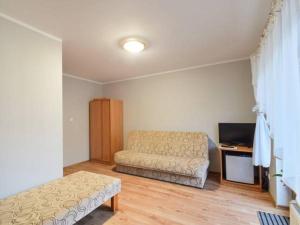 a living room with a couch and a television at Kwatery prywatne Maks in Pobierowo