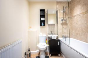 a bathroom with a toilet and a shower and a sink at No6 Nursery Convent in Mansfield