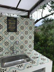 a sink on a counter with a wall at Areca Glamping SPA in Anapoima +41 photos