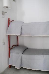 two bunk beds in a corner of a room at Una finestra sul glicine in Cirò Marina