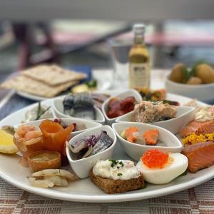 a plate of food with eggs and other foods at Norrfällsvikens Camping, Stugby & Marina in Mjällom