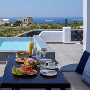 a tray of food on a table on a patio at Soil of Sun Luxury Villas in Megalokhori