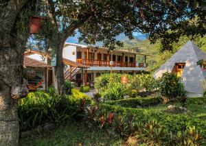 a view of the house from the garden at Hostería Paraíso in Vilcabamba