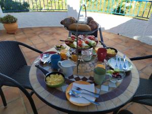a table with food on it on a patio at B&B la Madrugada in Cómpeta