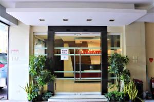 a front door of a building with potted plants at The Studio 18 Residences in Manila