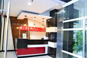a restaurant with a red door and a sign that reads the sun kitchens at The Studio 18 Residences in Manila