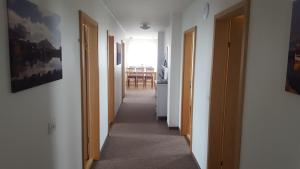 a hallway with two doors and a dining room at Höfn Guesthouse in Höfn