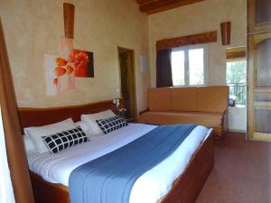 a bedroom with a large bed and a window at Les Chambres d'Hotes au Bois Fleuri in Roquebrune-sur-Argens +31 photos