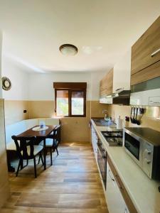 a kitchen with a table and a dining room at Apartament Sunshine in Orşova