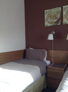 A bed or beds in a room at The Premier Lodge 