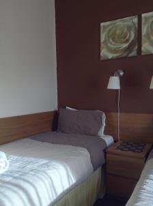 A bed or beds in a room at The Premier Lodge 