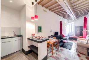 a kitchen and a living room with a table at 5 scole apartments in Rome