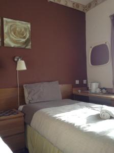 A bed or beds in a room at The Premier Lodge 