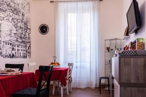 a dining room with a red table and a window at Monticello apartment via Cavour in Rome