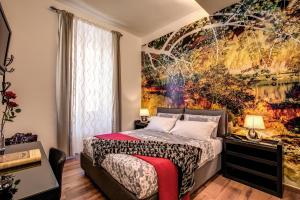 a bedroom with a large painting on the wall at Monticello apartment via Cavour in Rome